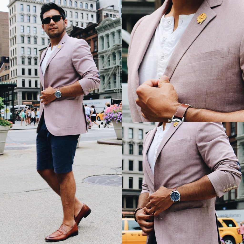 shorts and a pink blazer wearing loafers