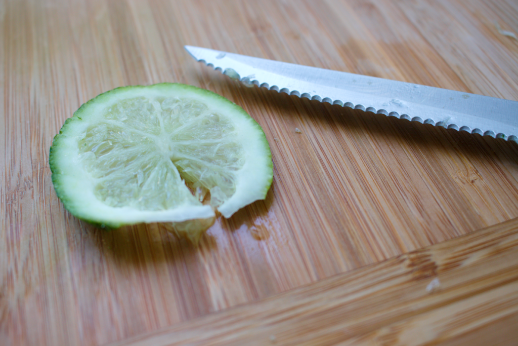 Making gin and tonic with Seagram’s Gin, garnishing a lime