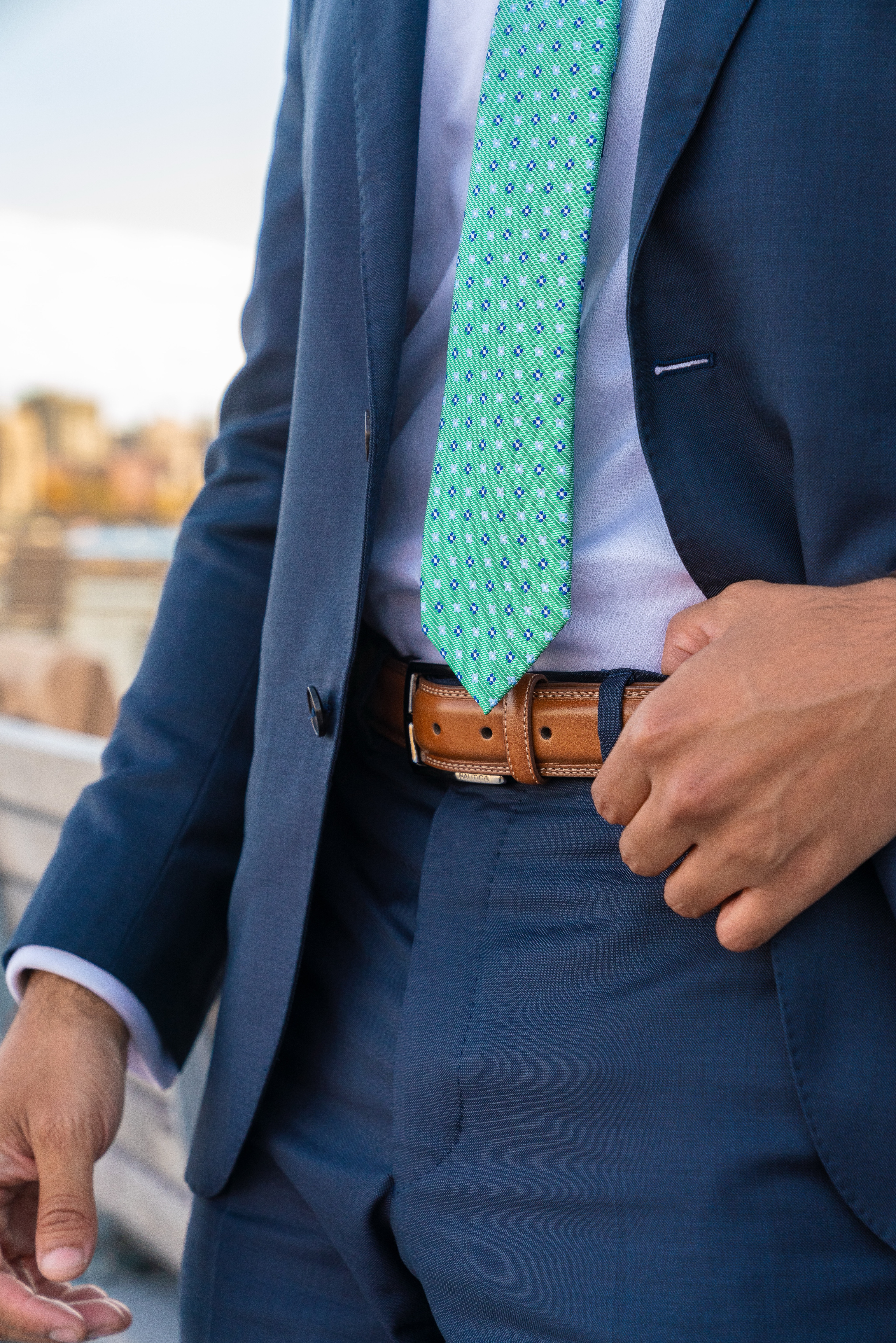 BASIC RULES WHEN WEARING A BELT  - wearing a brown belt with a blue navy suit for men - dandy in the bronx     Fashionable yet Functional. Belts can help keep your pants up while also adding a touch of contrast to your outfit. Here are some basic rules when wearing a belt. wearing a brown belt with a blue navy suit for men - dandy in the bronx