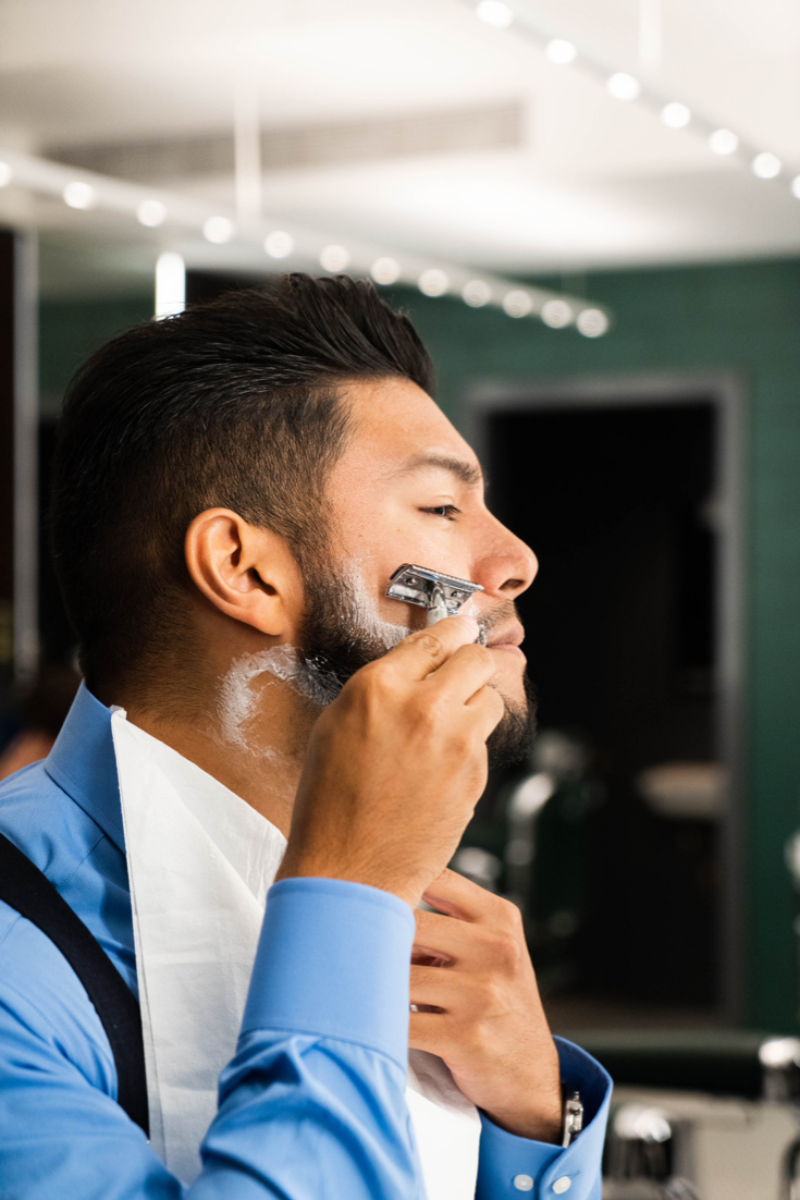 75-haarandcobarbershop-x-prorasousa-@sayjor - dandy in the bronx - man shaving his beard - latino
