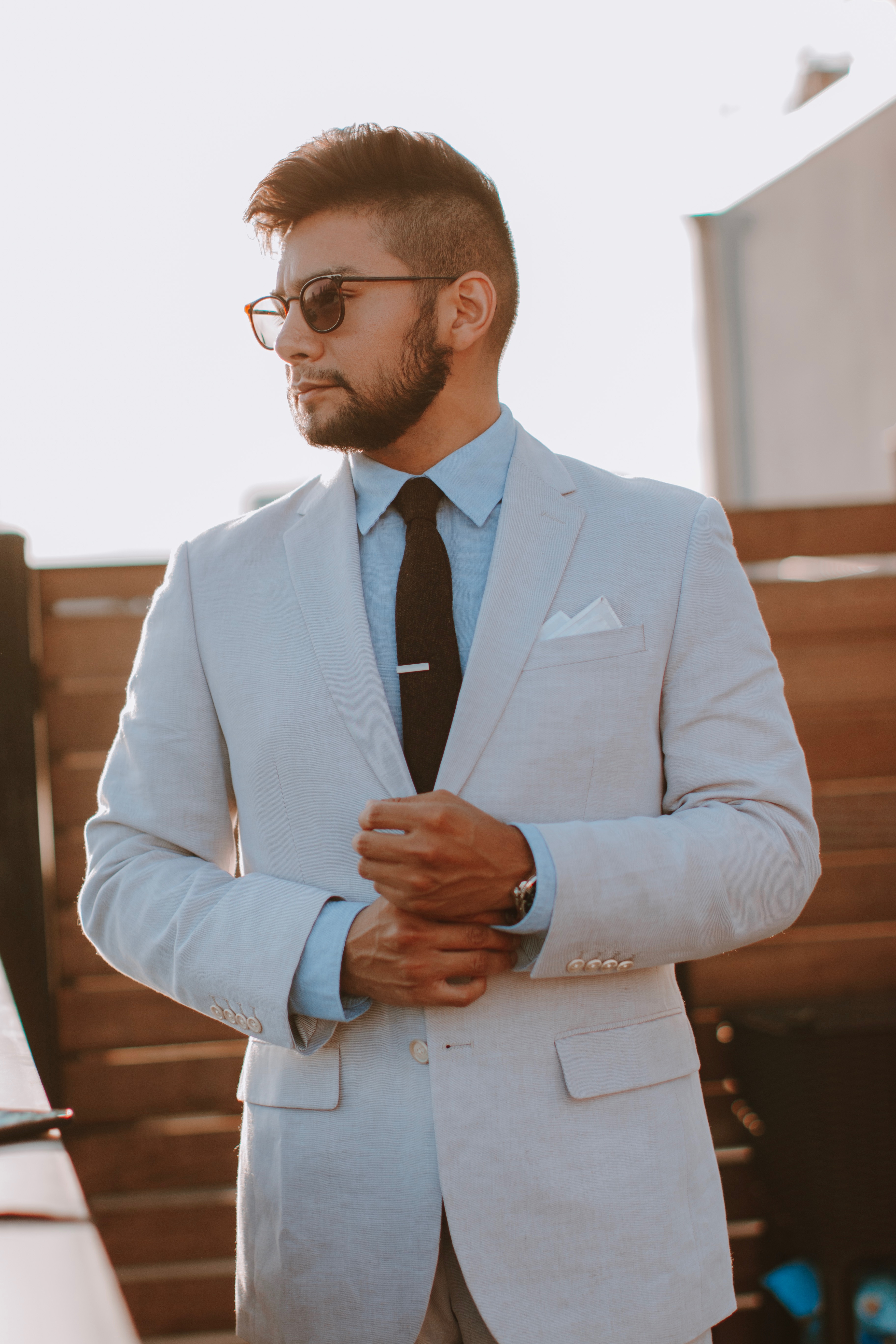 brown suit with blue shirt