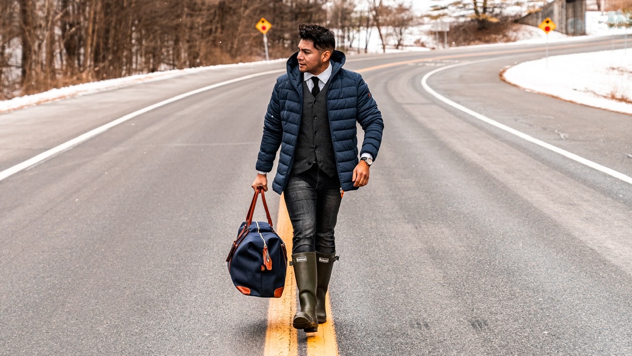 HOW TO STAY HEALTHY DURING HOLIDAY TRAVEL - man walking on the road holding a bag - dandy in the bronx