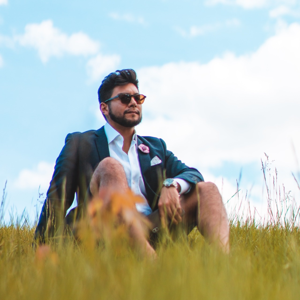 Man wearing suit shorts on the grass - dandy in the bronx