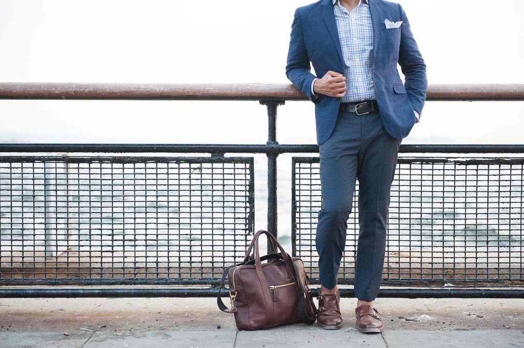 man in suit waiting by dock with a brown suit case - brown brief case - brown loafers - dandy in the bronx