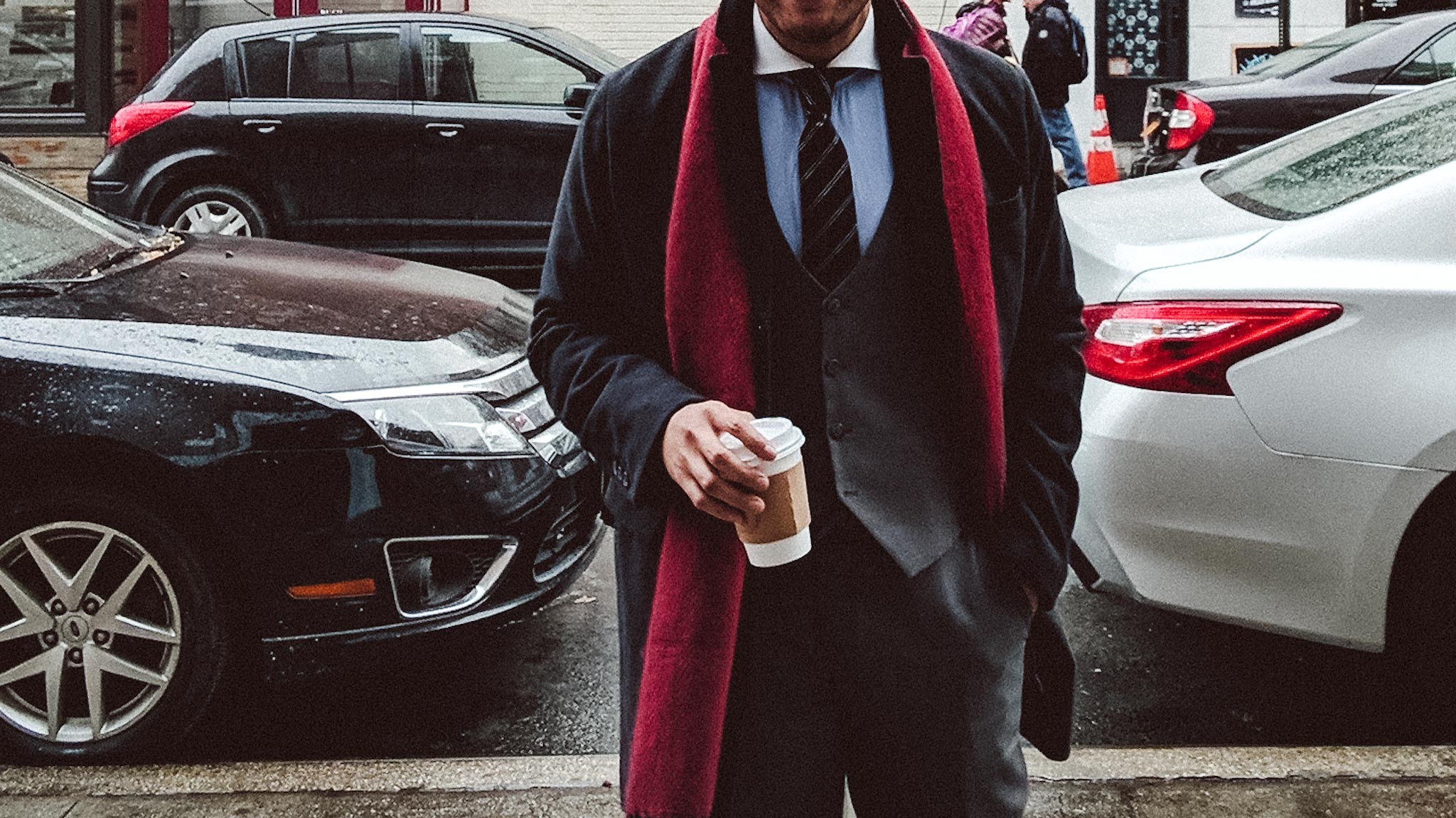 man in suit in front of cars - dandy in the bronx