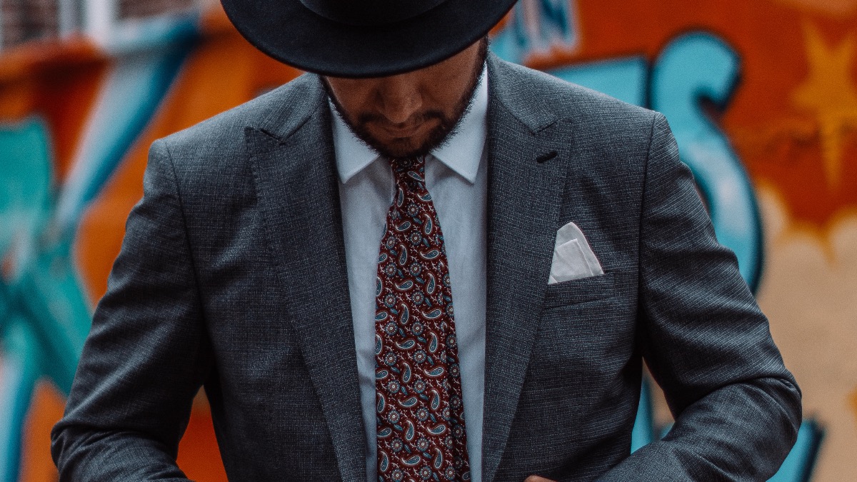 man with black hat and suit - Paisley tie - grey suit - dandy in the bronx - hunts point - red paisley suit