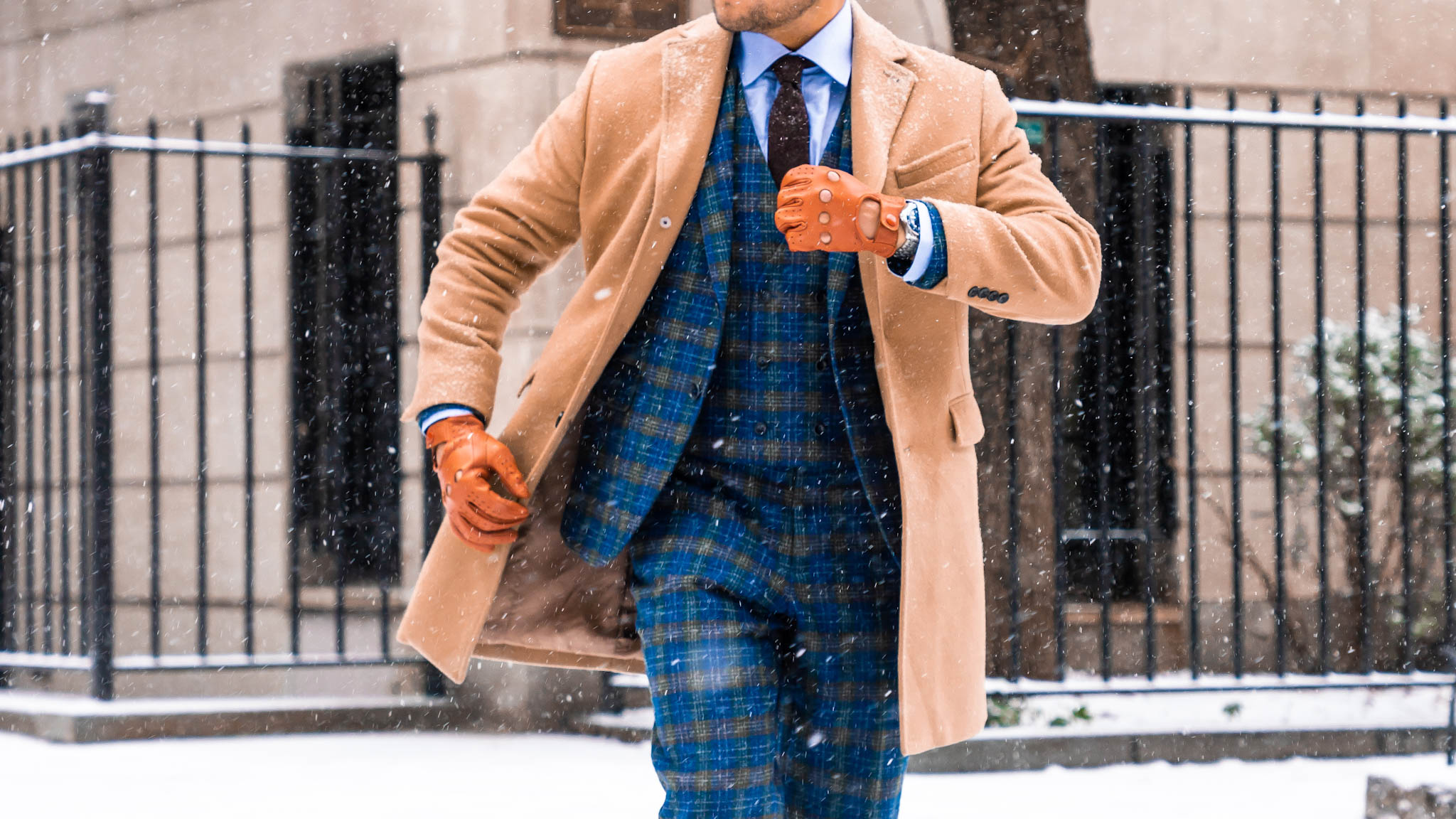 Man in snow - blue plaid suit - brown camel coat - plaid suit style - men plaid suit - how to wear plaid suit - blue plaid suit
