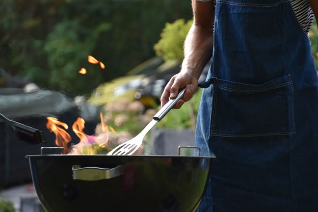 man grilling food in the summer