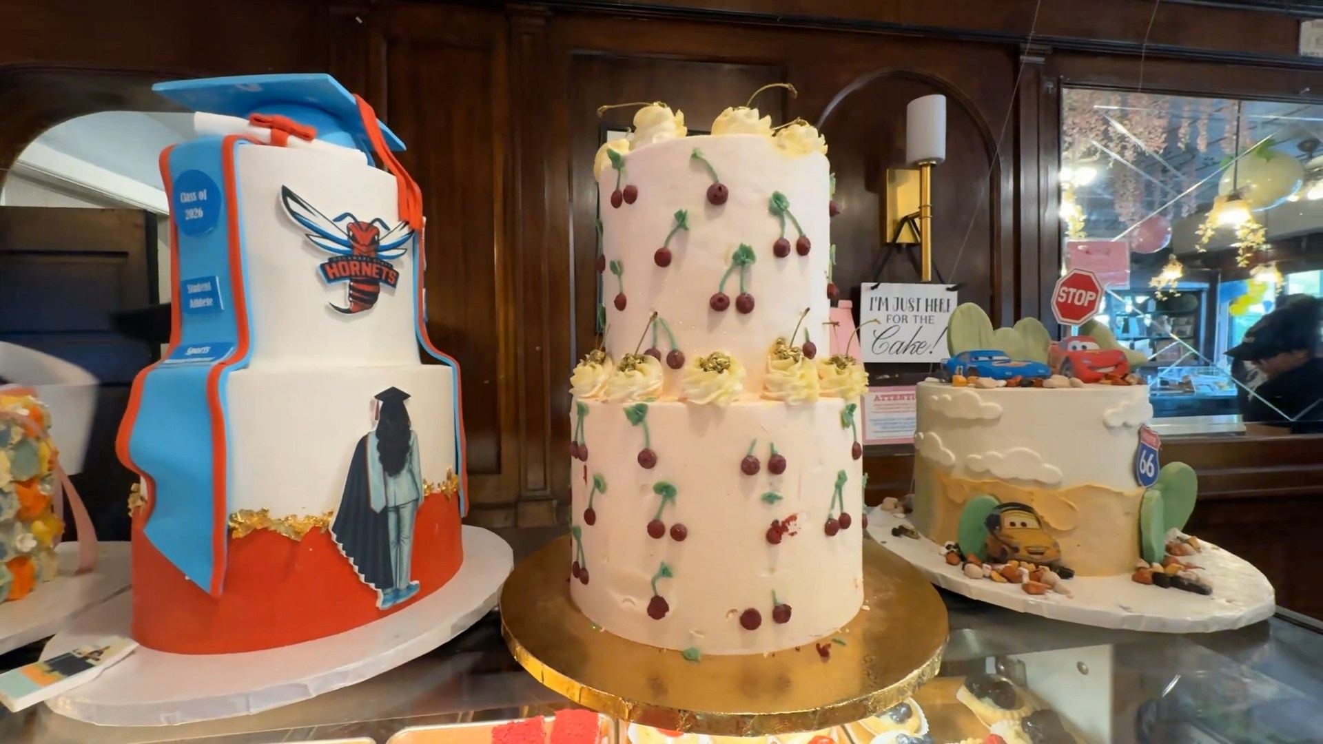 Conti's Pastry Shoppe in the Bronx display window featuring custom cakes