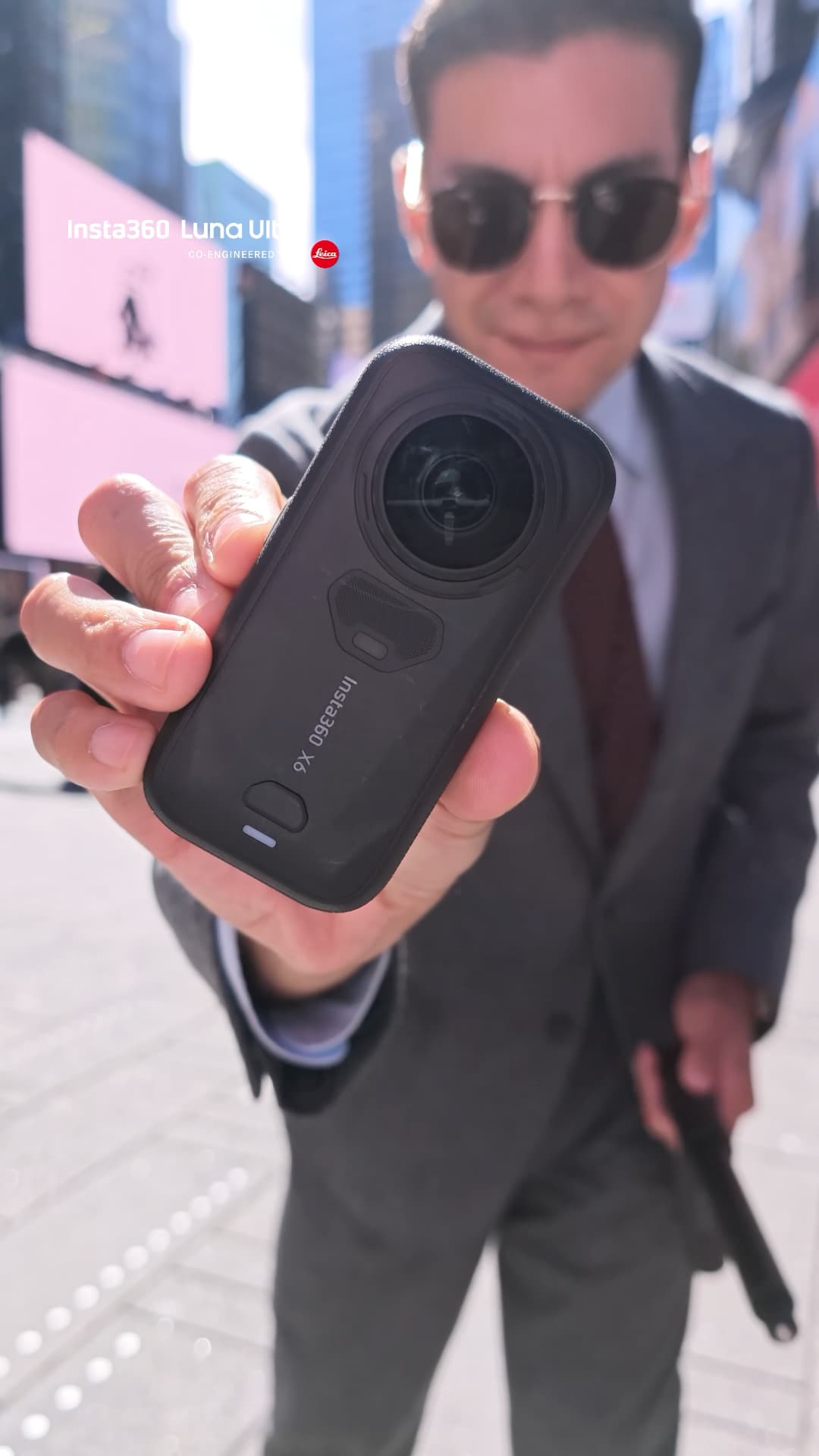 Diego Leon holding the Insta360 X6 360 camera in Times Square, photo taken with the Insta360 Luna Ultra