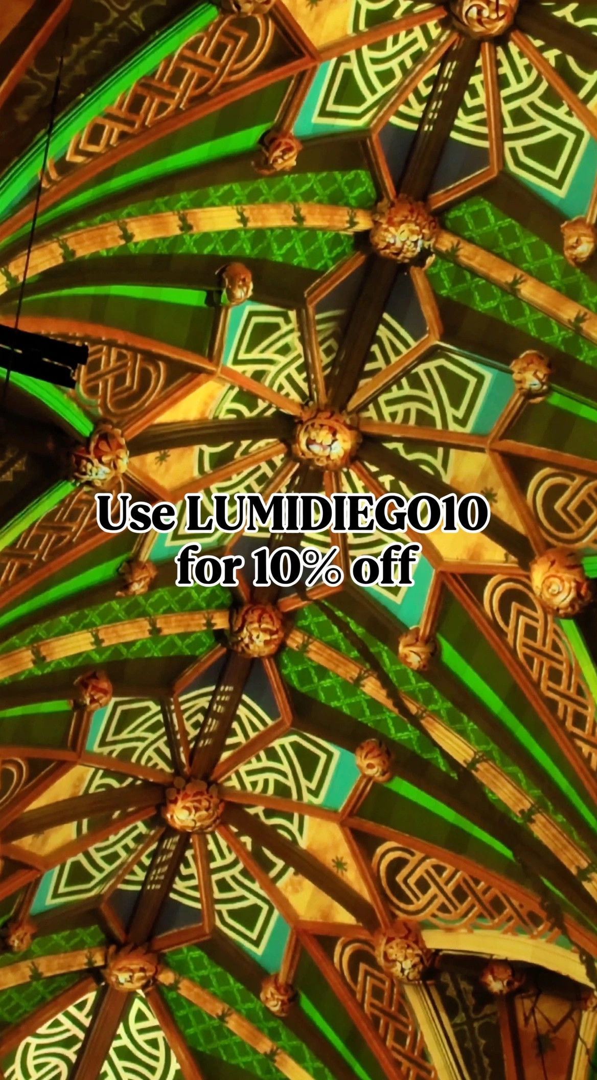 Graphic reading Use LUMIDIEGO10 for 10 percent off over green Celtic-pattern LUMINISCENCE projections at St. Patrick's Cathedral