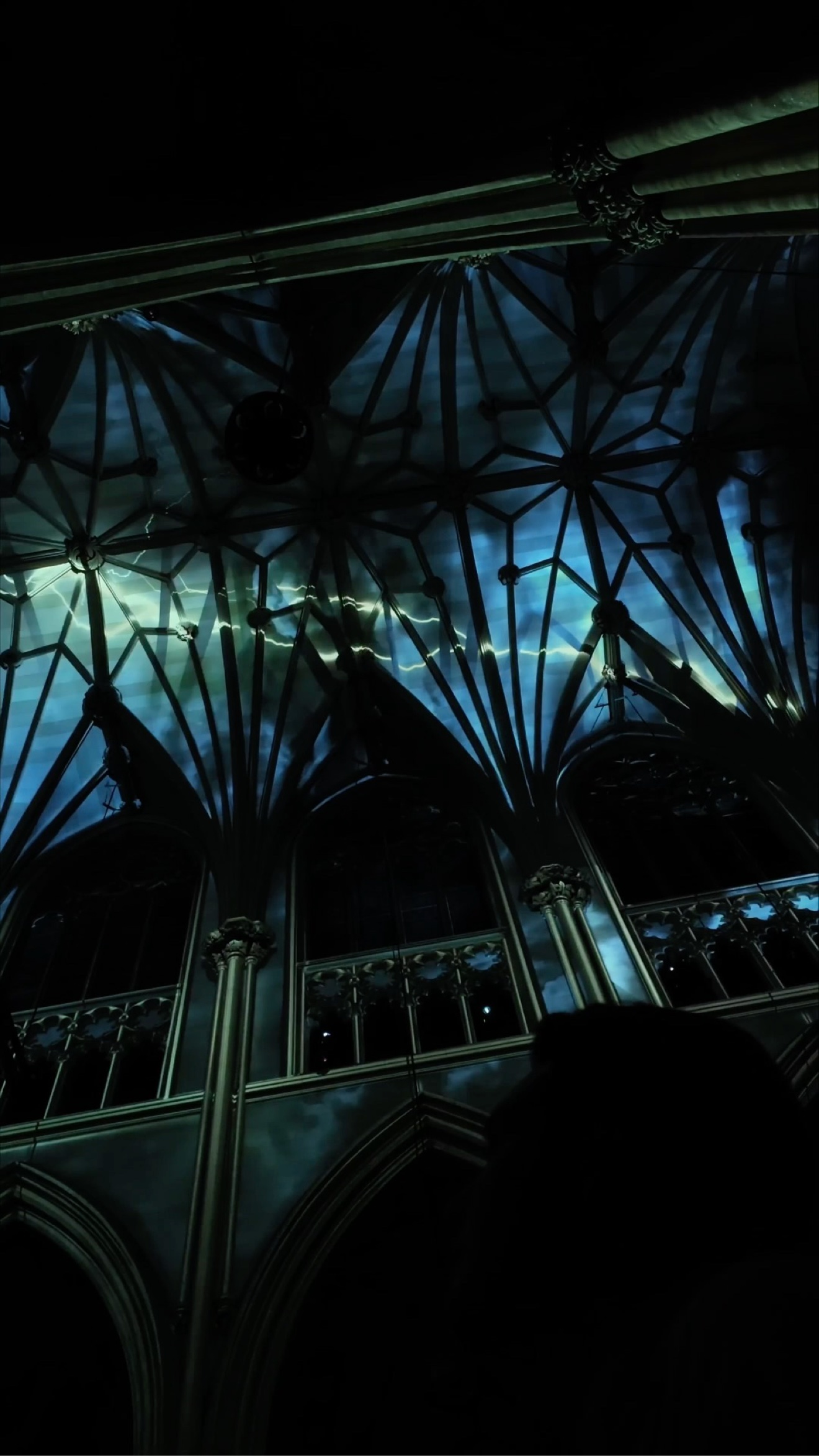 Dark blue storm-like LUMINISCENCE projections with light streaks across the vaulted ceiling of St. Patrick's Cathedral