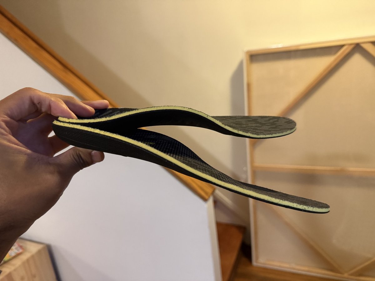 Side profile of PowerStep Pinnacle Work insoles showing the arch support curve